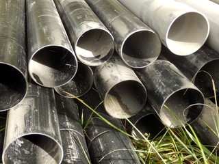 Drainage pipes stacked in preparation for a sand and gravel water filter system