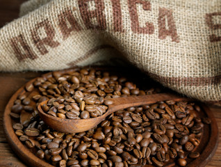 coffee beans with a burlap and wooden spoon
