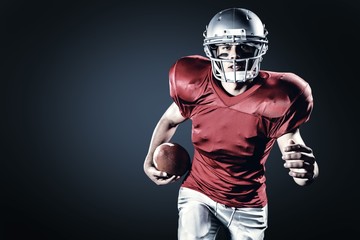 Portrait of sportsman running while holding ball