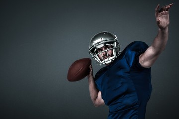 American football player throwing ball