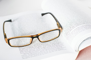 Eyeglass on book