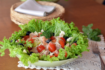 Mixed vegetable salad with chicken in the white bowl