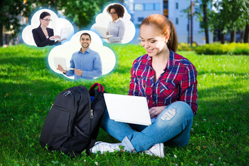 teenage student or school girl using laptop in park and clouds w