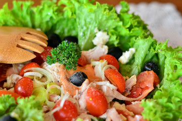 Mixed vegetable salad with chicken in the white bowl
