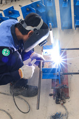 worker welding iron plate