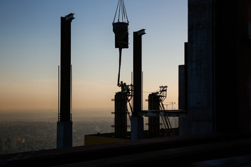 silhouette construct site and workers