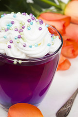 Colorful jelly with whipped cream and candy topping