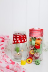 Boiled sweets and a candle in glass jars