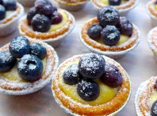The close view of blueberry tarts in teatime