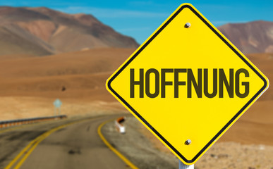 Hope (in German) sign on desert road