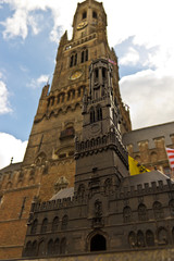Belfort (Belfry) building with identical statue in foreground