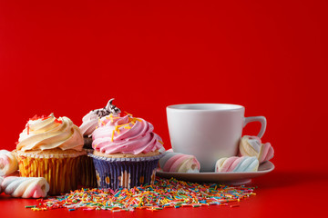 Fun children breakfast. Cupcake on brigth red background