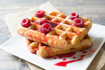 Waffles with raspberries and strawberry syrup