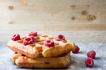 Waffles with raspberries and strawberry syrup