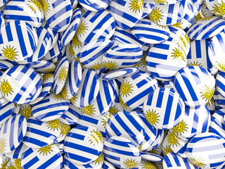 Background with round pins with flag of uruguay