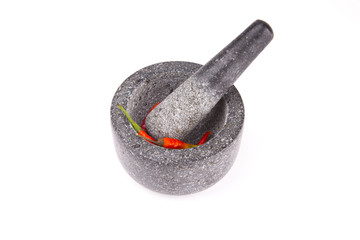 Chili peppers with mortar isolated on white background..