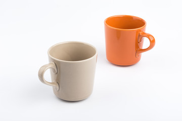 Orange offee cup and brown offee cup on white background