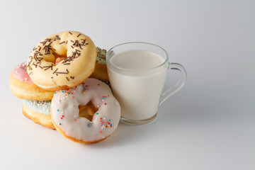 Colored donuts on white plain background