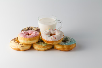 Colored donuts on white plain background