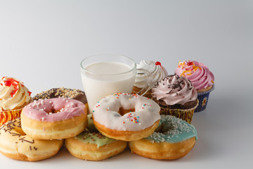 Obraz na płótnie Canvas Colored donuts on white plain background