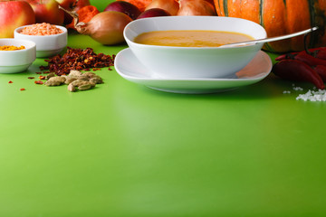 Pumpkin soup with onion and pepper on green shadowless backgroud