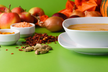 Pumpkin soup with onion and pepper on green shadowless backgroud