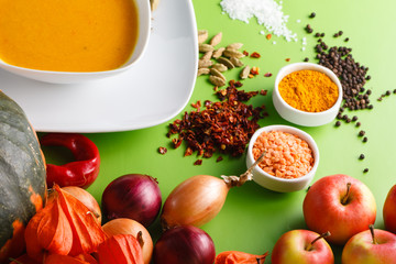 Pumpkin soup with onion and pepper on green shadowless backgroud
