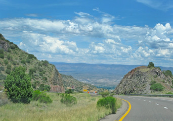 Road through landscape in Arizona, United States on a sunny and cloudy day in July.