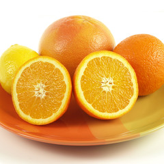 Juicy citrus fruit on orange plate, square