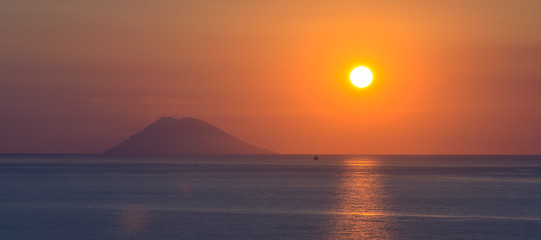 Sunset over Stromboli island seen from Calabrian shore, Italy. - 94156087