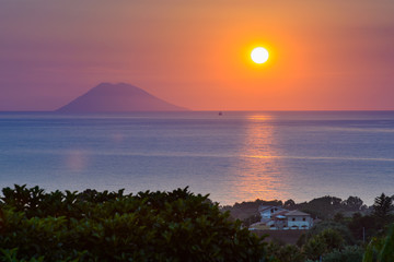 Sunset over Stromboli island seen from Calabrian shore, Italy. - 94156093