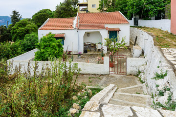 Fototapeta na wymiar A typical house and its yard in Afiaons village, Corfu island, Greece.