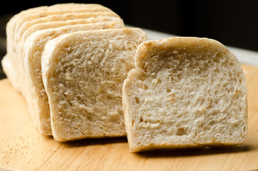 Whole wheat bread on wooden plate