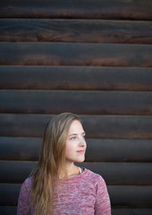 Portrait of Young Hipster Woman on Wooden Wall Background