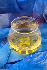 Glass of cognac wrapped in blue cloth