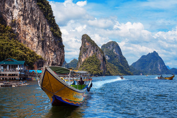 long boat and rocks on railay beach in Thailand