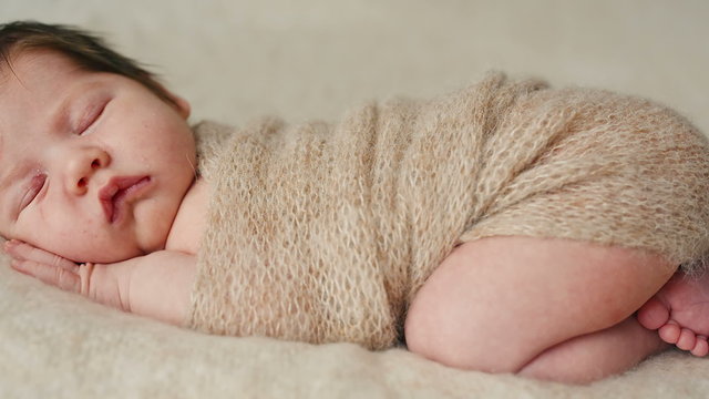 Cute newborn baby sleeping on a blanket