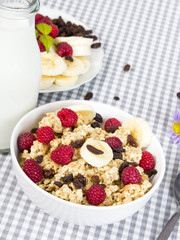 granola with fruits and bottle of fresh milk
