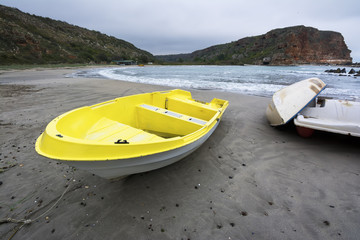 Lonely yellow boat at the seaside