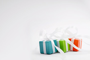 Gifts for Christmas or a birthday - three colourful packages - obrazy, fototapety, plakaty