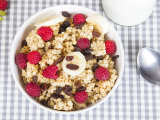 granola with fruits and bottle of fresh milk
