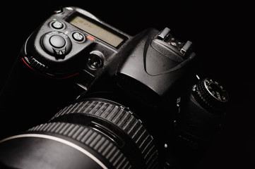 professional digital photo camera against black background