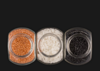 Gourmet sea salts in glass containers, Alaea and black lava sea salt as well as raw sea salt from Thailand.