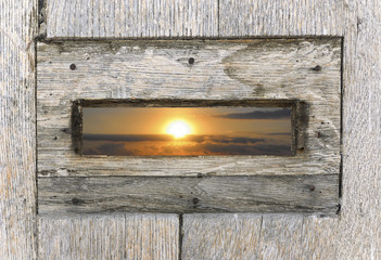 View from the inside of a mailbox. Amazing sunrise, on summer end season. The day begin to get light with some clouds at horizon.