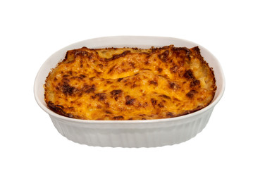 Lasagna in baking dish on a white background