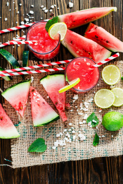 salad with watermelon and feta cheese and watermelon smoothie with mint and lime on the wooden background