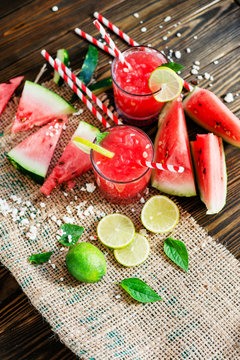 salad with watermelon and feta cheese and watermelon smoothie with mint and lime on the wooden background