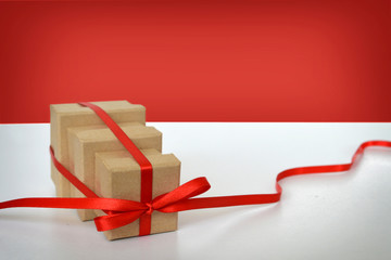 Three gift boxes tied together with red ribbon