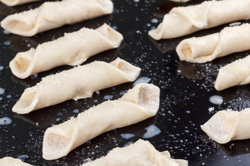 Raw sugar cookies baking in oven.