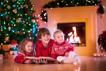 Kids playing at fireplace on Christmas eve